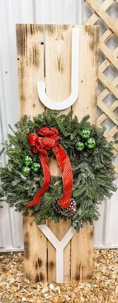 Wooden JOY sign with a fresh wreath as the O